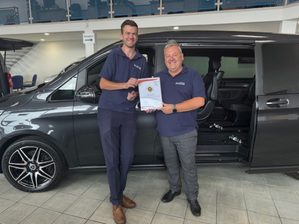 Jubilee Salesmen holding customer service award